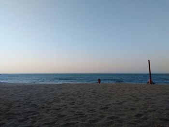 Scenic view of beach against clear sky