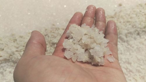 Close-up of hand holding sand
