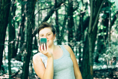 Portrait of young woman in forest