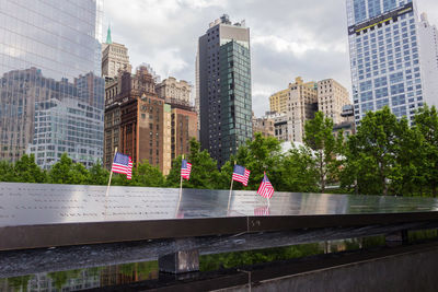 Low angle view of flag against buildings in city