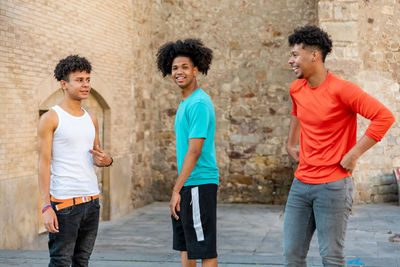 Group of afro latin male friends dancing in the street