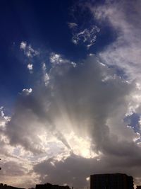 Low angle view of building against cloudy sky