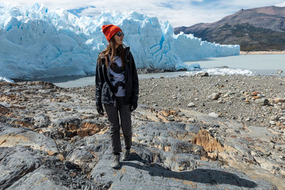 Full length of woman standing on rock