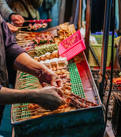 Close-up of man preparing food for sale at market stall