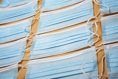 Surgical masks on an orange table.