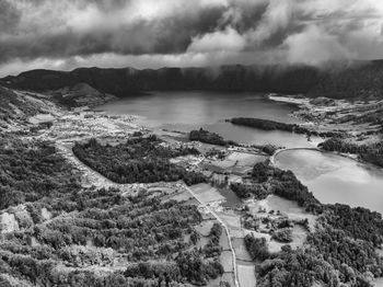 Scenic view of river and mountains against sky