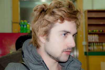 Close-up of young man looking away in store