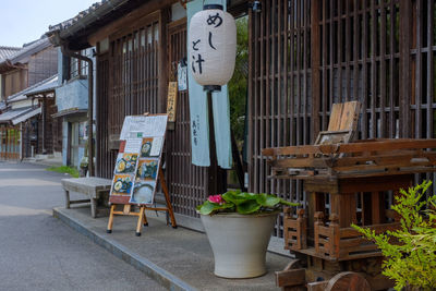 Potted plants hanging outside building