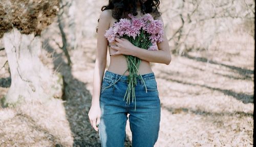 Midsection of man holding bouquet