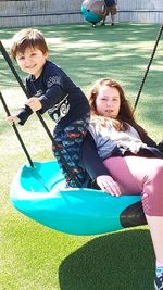 Full length of children on slide at playground