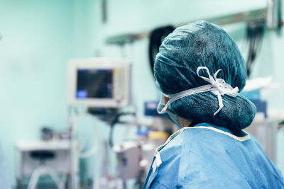 Rear view of doctor wearing surgical cap
