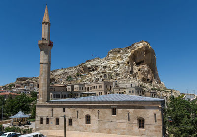 Low angle view of building against clear blue sky