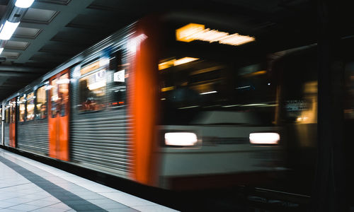 Blurred motion of train at railroad station