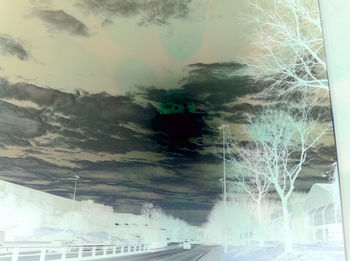 Digital composite image of car on road against sky