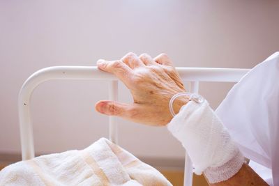 Cropped hand of patient with iv drip