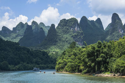 Panoramic view of trees and mountains against sky