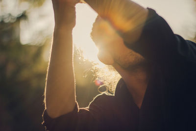 Close-up of thoughtful man dancing during sunny day