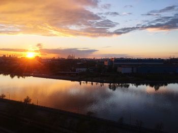 View of city at waterfront during sunset