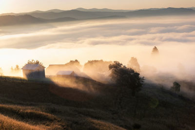 High angle view of houses on mountain during foggy weather