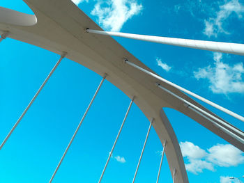 Low angle view of suspension bridge against sky