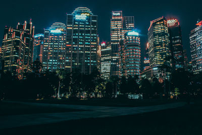 Illuminated cityscape against sky at night