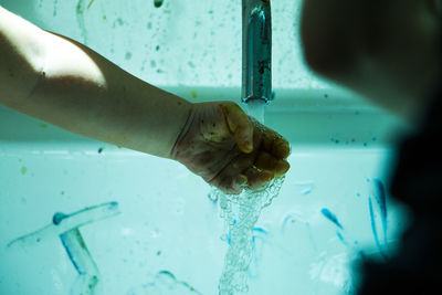 Close-up of hands working in water