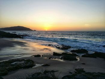 Scenic view of sea against clear sky during sunset