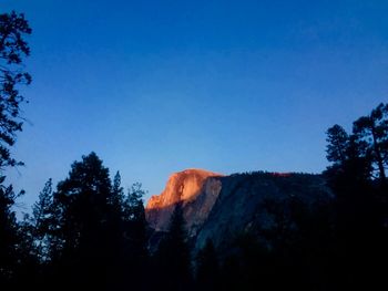 Low angle view of a mountain against blue sky