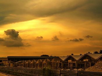 Scenic view of dramatic sky over beach during sunset