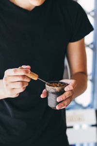 Midsection of man holding ice cream