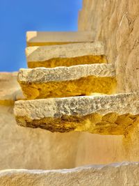 Low angle view of stone wall against sky