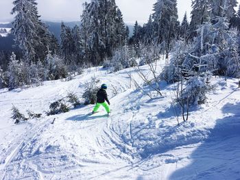 High angle view of boy skiing on slope during winter