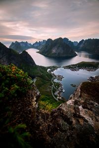 Scenic view of sea and mountains against sky during sunset