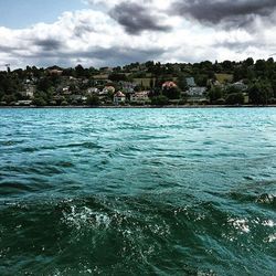 River in city against cloudy sky