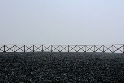 Fence on field against sky