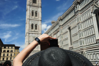 Low angle view of woman photographing italy