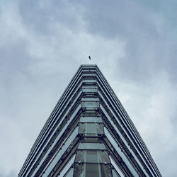 Low angle view of building against cloudy sky