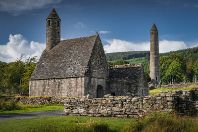 Medieval church, ancient graves, celtic crosses in glendalough cemetery, ireland