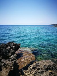 Scenic view of sea against clear blue sky