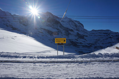 Overhead cable car over snowcapped mountains against sky