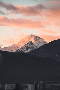 Scenic view of snowcapped mountains against sky during sunset