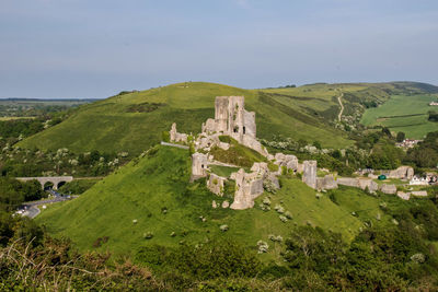 Corfe castle on mountain against sky at dorset
