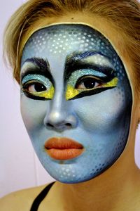 Close-up portrait of young woman with face paint