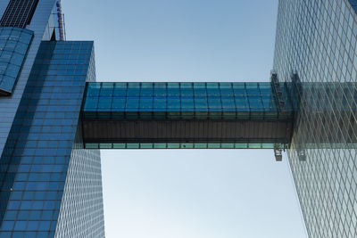 Low angle view of modern building against clear blue sky