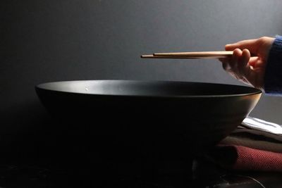 Close-up of hand holding bowl