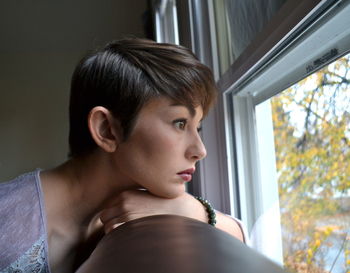 Close-up portrait of young woman looking away