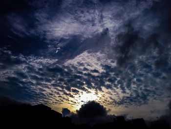 Low angle view of silhouette trees against sky
