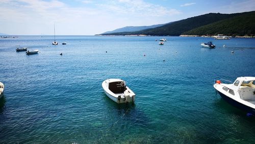 Boats in sea against sky