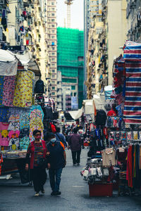 Rear view of people on street market in city
