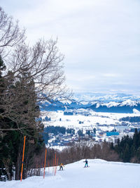 Snow covered landscape against sky